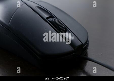 Photo of a computer mouse on a wooden table. Stock Photo