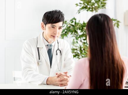 Doctor talking to patient in office Stock Photo