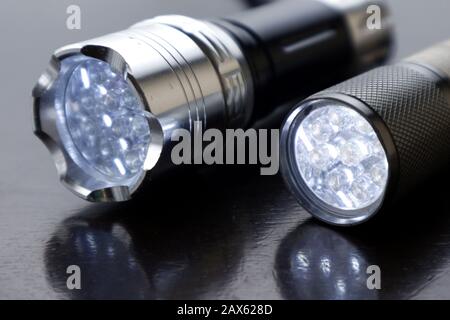 Close up photo of small led flashlight on a wooden table Stock Photo