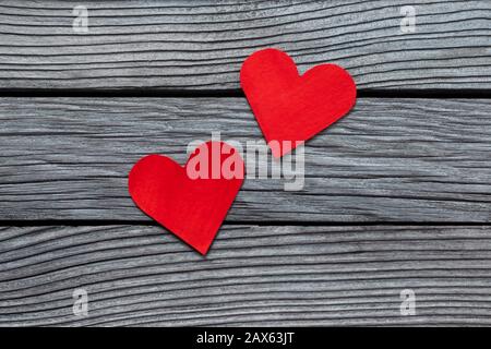 Bright red paper hearts on gray textured wooden background Stock Photo