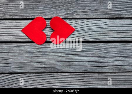 Two red paper hearts in shape of kissing lips on textured gray wood Stock Photo