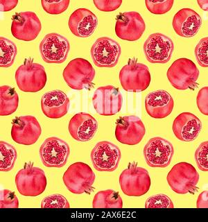 Seamless pattern of red pomegranates on yellow background isolated close up, whole and cut pomegranate with seeds repeating ornament, wallpaper Stock Photo