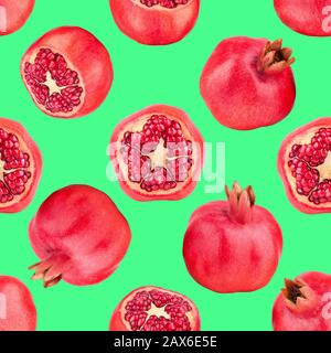 Seamless pattern of red pomegranates on green background isolated close up, whole and cut pomegranate with seeds repeating ornament, wallpaper Stock Photo