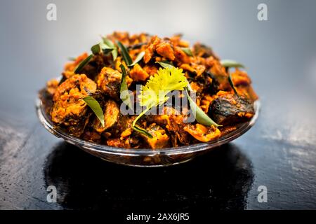 Famous Indian & Gujarati snack dish in a glass plate on wooden surface i.e. Patra or paatra consisting of mainly Colocasia esculenta or arbi ke pan or Stock Photo