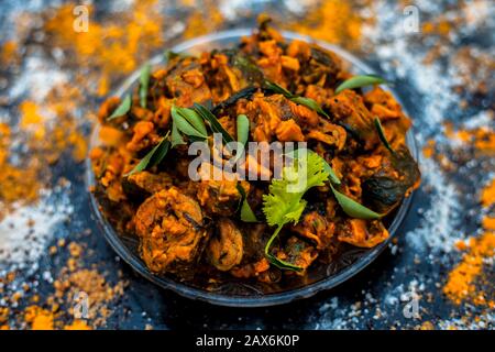 Famous Indian & Gujarati snack dish in a glass plate on wooden surface i.e. Patra or paatra consisting of mainly Colocasia esculenta or arbi ke pan or Stock Photo