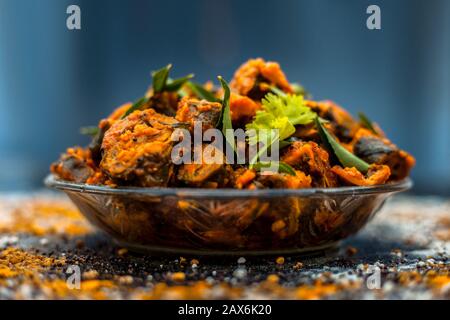 Famous Indian & Gujarati snack dish in a glass plate on wooden surface i.e. Patra or paatra consisting of mainly Colocasia esculenta or arbi ke pan or Stock Photo