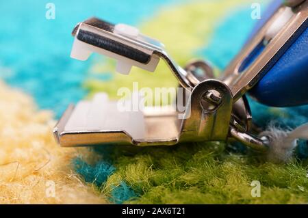 Closeup shot of a metal tool over a multicolored surface Stock Photo