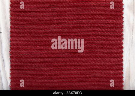 tissue structure closeup. fiber texture polyester close-up. fine grain felt red fabric background. Stock Photo