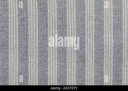 Fabric striped texture. Rustic canvas pattern. Colored striped coarse gray fabric closeup as background. Stock Photo