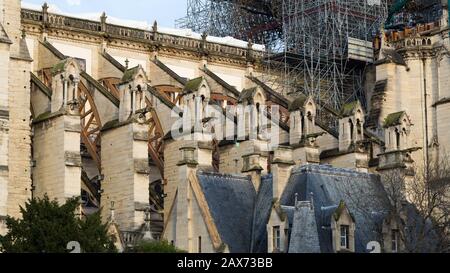 View on the flying buttresses of Notre Dame. The catholic cathedral was heavily damaged during a fire on April 19, 2019. With melted scaffolding. Stock Photo