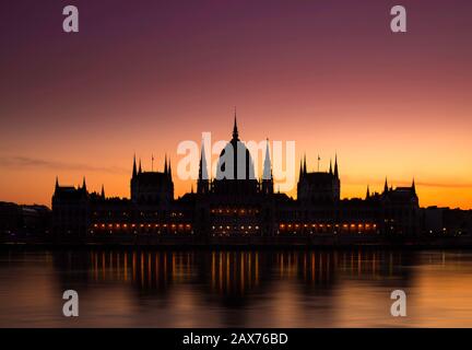 Budapest, Hungary - The Hungarian Parliament building on a colorful winter dawn with golden and red sky and River Danube Stock Photo