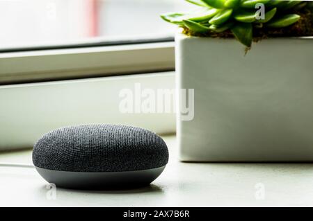 A charcoal black smart speaker at home. Smart home technology. Stock Photo