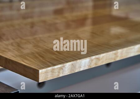 Sycamore maple cabinet door in workshop. High gloss cabinet door. Furniture manufacture. Close-up Stock Photo