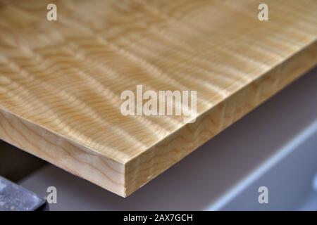 Sycamore maple cabinet door in workshop. High gloss cabinet door. Furniture manufacture. Close-up Stock Photo