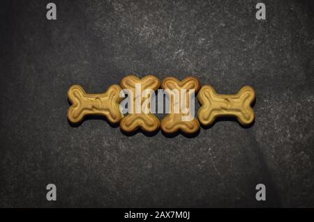 bone shape dog biscuit on the black background Stock Photo