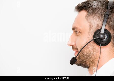 Side view of smiling operator of call center in headphones Stock Photo