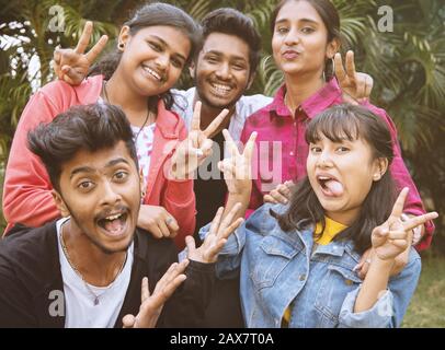 Young teenage friends taking selfie with funny faces - Concept of youth happy friendship having fun together - Millennials of selfie generation. Stock Photo