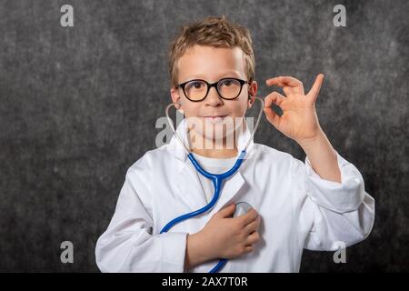 Cute kid boy wear medical uniform playing doctor, a portrait Stock Photo