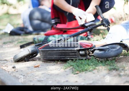 First aid after electric scooter accident Stock Photo