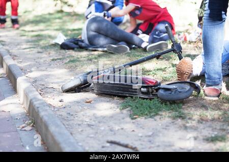 First aid after electric scooter accident Stock Photo