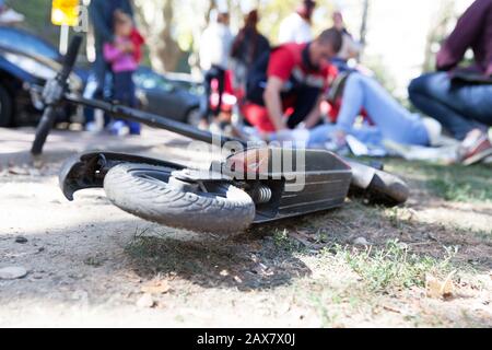 First aid after electric scooter accident Stock Photo