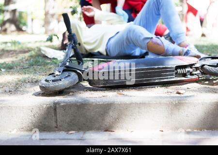 First aid after electric scooter accident Stock Photo