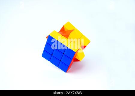A nice rubik cube which is solved is displayed on an isolated white background Stock Photo