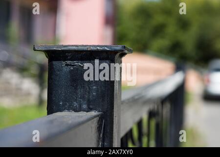 Black fence pole close up with blurred background, copy space Stock Photo