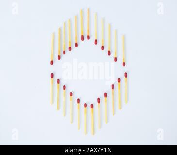 Two opposite directed row of red wooden matchsticks arranged as a frame on a white background Stock Photo