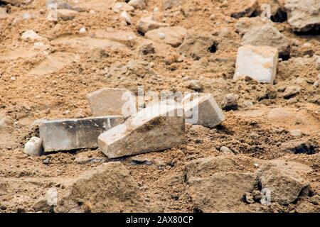 Broken bricks on the sand on the construction site, building Stock Photo