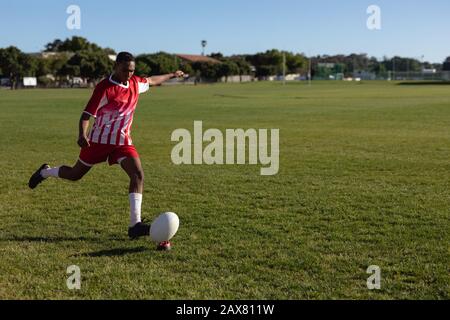 Rugby player shooting in the ball Stock Photo