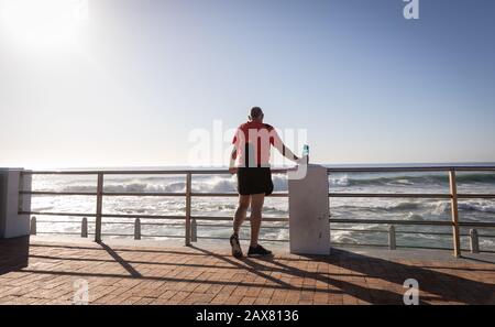 Jogger stretching on seaside Stock Photo