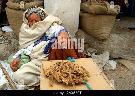 A sleeping tobacco salesman, Tunisia. Stock Photo