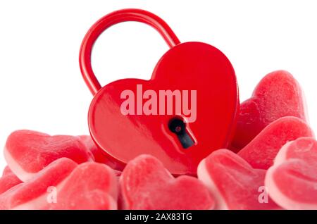 heart padlock on top of candy isolated on white background Stock Photo