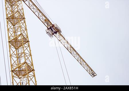 Yellow construction crane on the sky background, bottom view Stock Photo