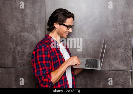 handsome young man in glasses using laptop, he chatting with friends Stock Photo