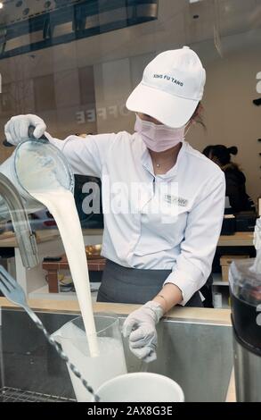 A young Asian American prepares boba drinks in the window at Xing Fu Tang, a Taiwanese store on Main St. in Flushing, Queens, New York's Chinatown. Stock Photo