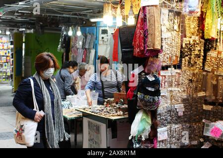 Shopper with Face Mask at Market Stalls, Central, Hong Kong during Outbreak of Coronavirus, 2020. Stock Photo