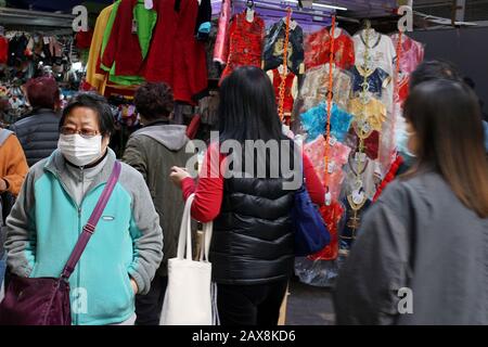 Shopper with Face Mask at Market Stalls, Wan Chai; Hong Kong during Outbreak of Coronavirus, 2020. Stock Photo
