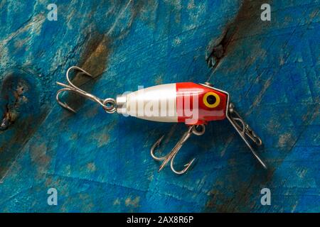 An old wooden fishing lure equipped with three treble hooks for catching  predatory fish. From a collection of vintage and modern fishing tackle.  North Stock Photo - Alamy