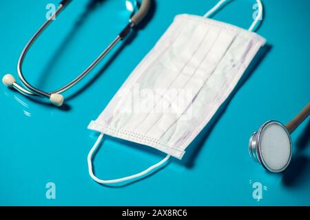 Medical items- mask and phonendoscope on blue background. Medicine and healthcare concept Stock Photo