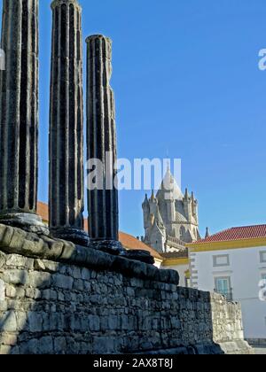 Roman Temple of Évora. In the background the Gothic Cathedral Tower Stock Photo