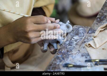 A woman carving an elephant at Artisans d'Angkor, a workshop creating job opportunities for craftsmen and women in rural areas, Siem Reap, Cambodia Stock Photo