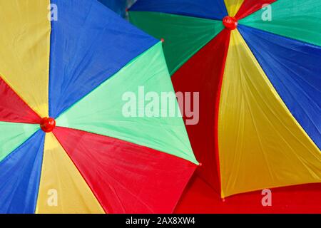 detail of two decorative and festive colorful carnival umbrellas Stock Photo