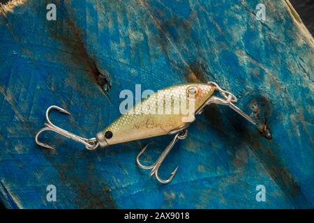 An old wooden fishing lure equipped with three treble hooks for catching  predatory fish. From a collection of vintage and modern fishing tackle.  North Stock Photo - Alamy