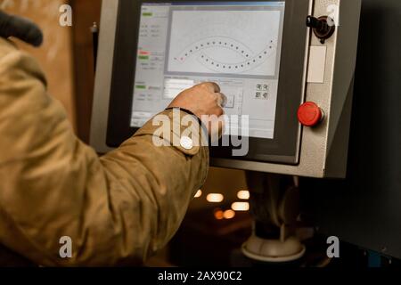 Worker operator using dashboard of CNC machinery or control at machine on the factory. industrial and Manufacturing concept Stock Photo