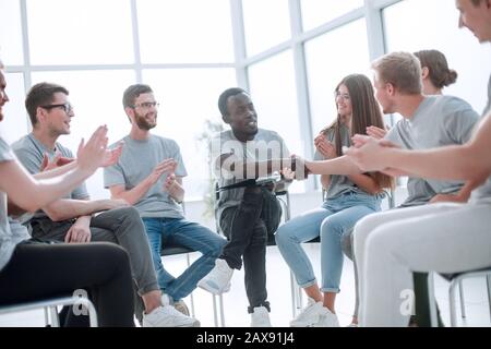 group of young people greeted the speaker with their applause Stock Photo