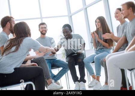 group of young people greeted the speaker with their applause Stock Photo