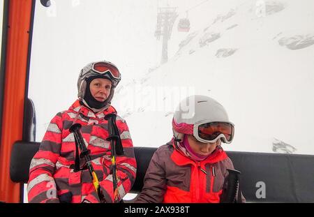 Family riding cabin cable car on winter vacation skiing. Family on winter vacations ski trip taking selfie inside of cabin with amazing mountain view Stock Photo