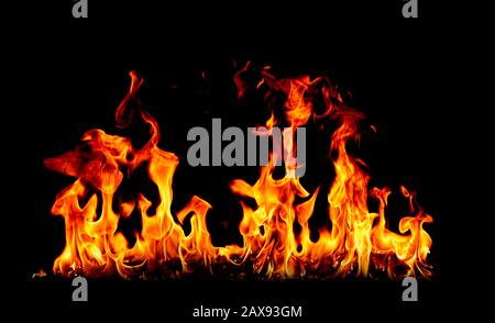 On fire flames at the black background, Burning red hot sparks rise, Fiery orange glowing flying particles Stock Photo